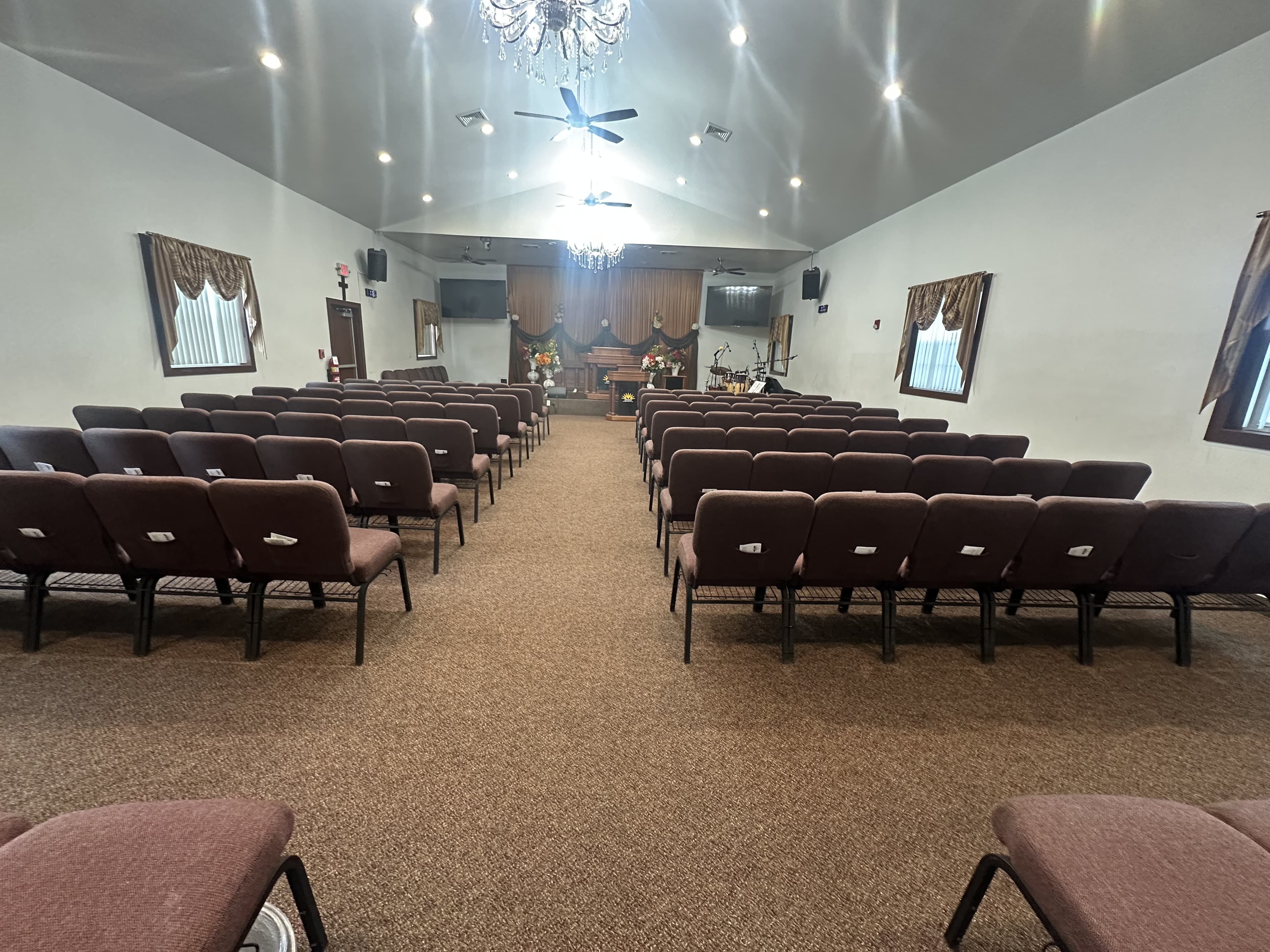 Empty seats waiting down the center aisle of the Adonai Outreach Ministry sanctuary