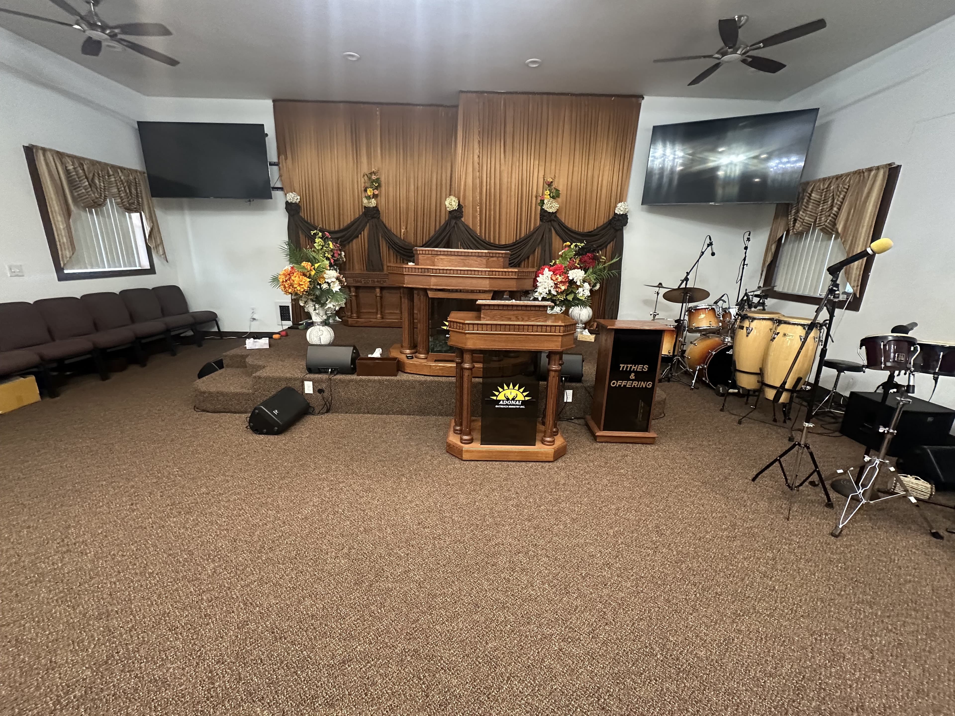 The sanctuary front at Adonai Outreach Ministry — pulpit, altar, and flowers